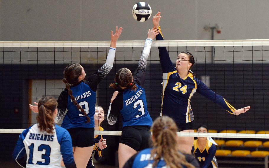 Ansbach’s Kennedy Lange hits the ball over the net as Patricia Rullan and Lucia Martinez of Brussels defend. Ansbach defeated Brussels 25-21, 17-25, 25-20, 25, 20, in the Division III final at the DODEA-Europe volleyball championships at Ramstein, Germany, Oct. 28, 2023.