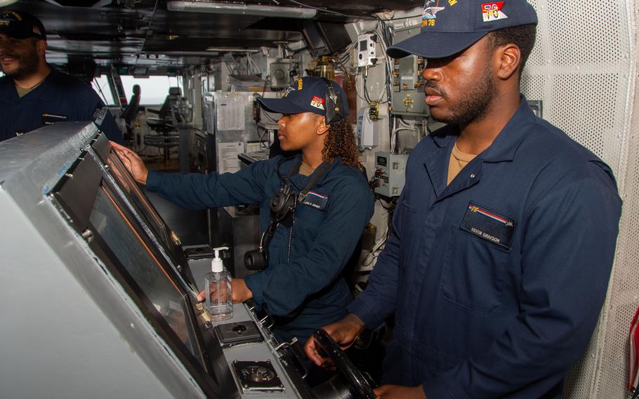 Seaman Kevon Grayson steers the aircraft carrier USS Ronald Reagan in the Philippine Sea on May 28, 2024. 