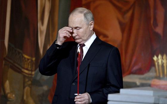 Russian President Vladimir Putin attends the Orthodox Easter service at the Cathedral of Christ the Saviour in Moscow, Russia, Sunday, May 5, 2024. (Pavel Bednyakov, Sputnik, Kremlin Pool Photo via AP)