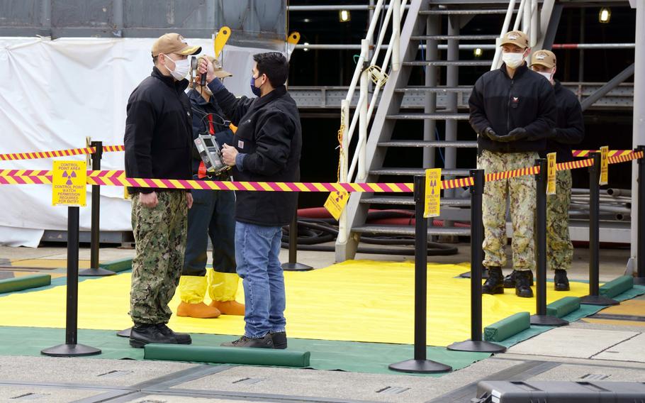 Sailors assigned to the aircraft carrier USS Ronald Reagan are screened for radiation exposure during an exercise at Yokosuka Naval Base, Japan, Feb. 2, 2023.