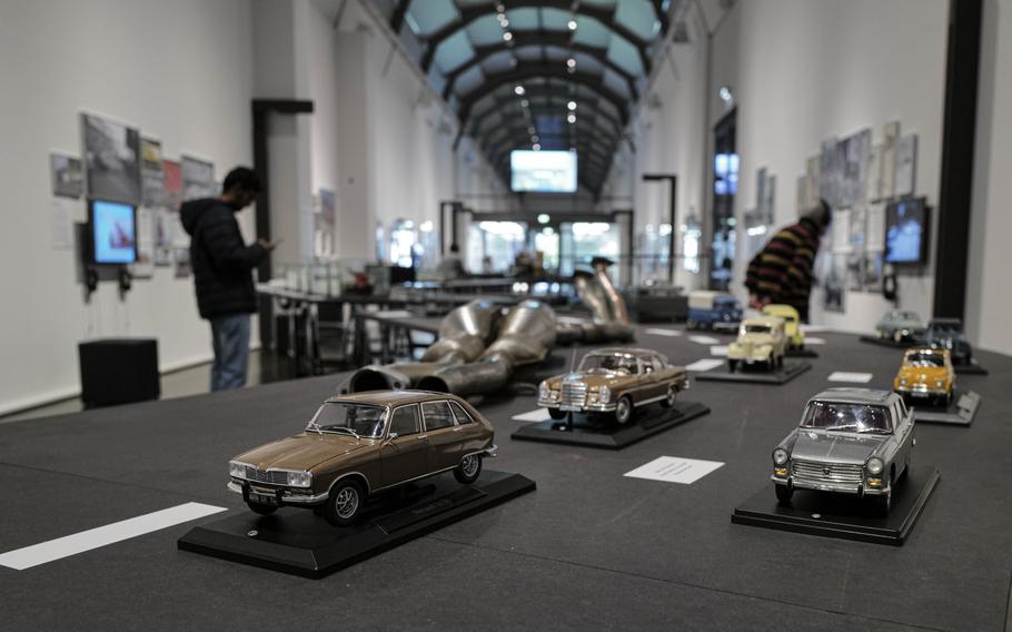 Visitors explore a temporary exhibit on automobile culture in Saarland at the Saar Historical Museum in Saarbruecken, Germany, on Oct. 19, 2023. The exhibit offers insights into the Saar region's deep connection to the car industry, showcasing its historical significance and impact.