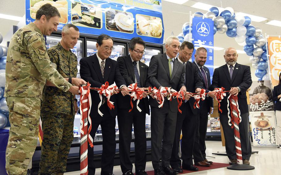 U.S. Ambassador to Japan Rahm Emanuel, center, leads a ribbon-cutting ceremony kicking off the sale of Hokkaido scallops at the commissary on Yokota Air Base, Japan, Tuesday, Oct. 31, 2023. He’s joined by representatives of Japan’s government, the Hokkaido Federation of Fisheries Cooperative Associations, the Defense Commissary Agency, base commander Air Force Col. Andrew Roddan and Marine Corps Brig. Gen. George B. Rowell, the deputy commander of U.S. Forces Japan.