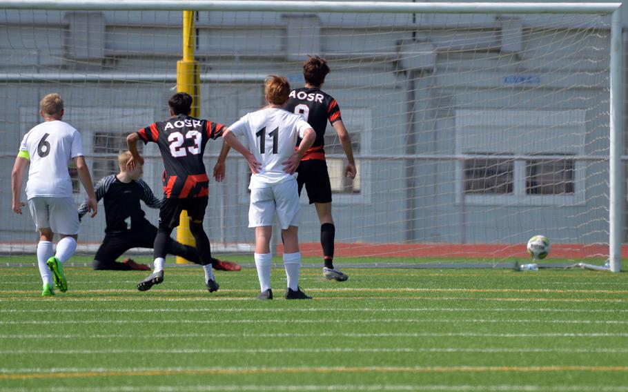 AOSR’s Gabriele Ghione, right, sends Naples keeper Mayo Urban the wrong way as he scores on a penalty in the boys Division II final at the DODEA-Europe soccer championships in Ramstein, Germany, May 18, 2023. AOSR won 5-1 to take the title.