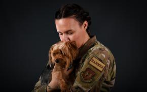 Air Force Chief Master Sgt. Melissa Robbins shares a tender moment with her Yorkshire terrier Archer at Incirlik Air Base in Turkey on Dec. 8, 2023. Archer is the first service member pet at the base since 2016, when a ban took effect. Personnel stationed at the base are once again allowed to have pets, after a new policy was adopted in October. 