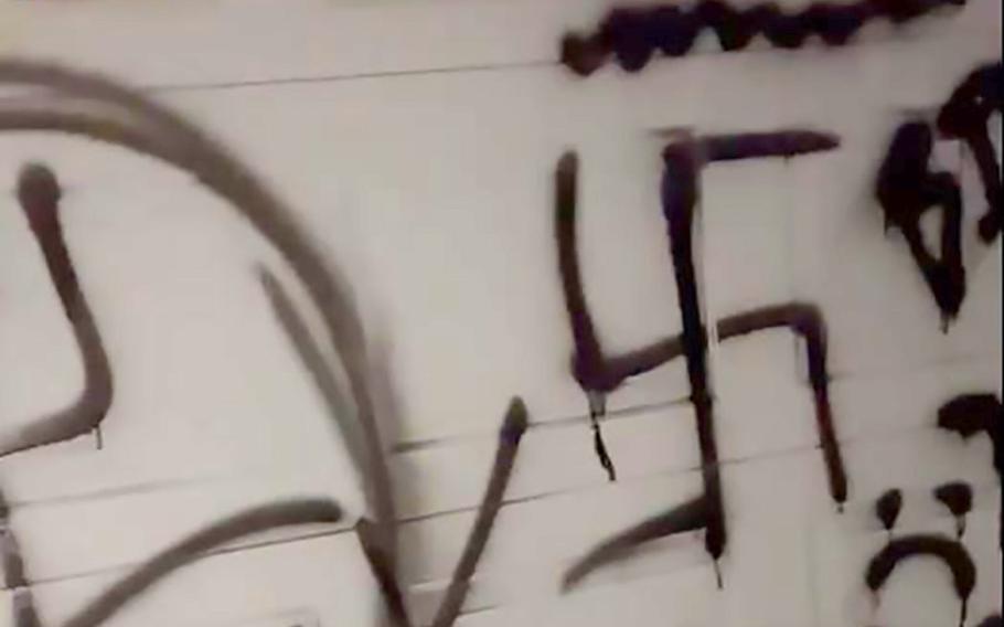 MacKenzy Rutledge said the garage door of her home at Minot Air Force Base, N.D., was vandalized with racist graffiti early Saturday morning, shown in this screenshot from video. Base security forces are investigating and ask anyone with information to call 701-723-3096.