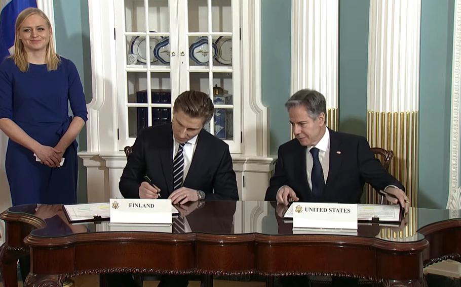 U.S. Secretary of State Antony Blinken, right, and Finnish Defense Minister Antti Hakkanen sign a defense cooperation agreement in Washington on Dec. 18, 2023, in a screenshot from YouTube.