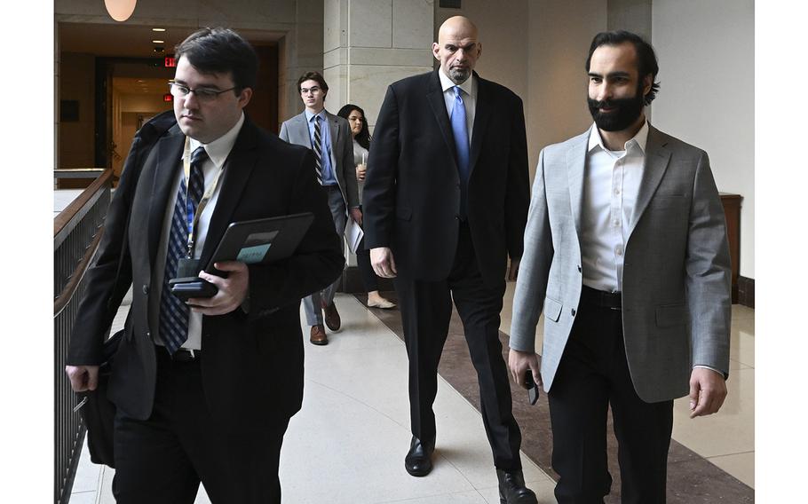 Sen. John Fetterman, D-Pa., center, walks through a corridor on Capitol Hill in Washington, D.C., on Feb. 14, 2023. 