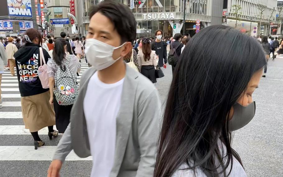 A man wears a mask as he walks in Tokyo on Tuesday, Sept. 28, 2021. 