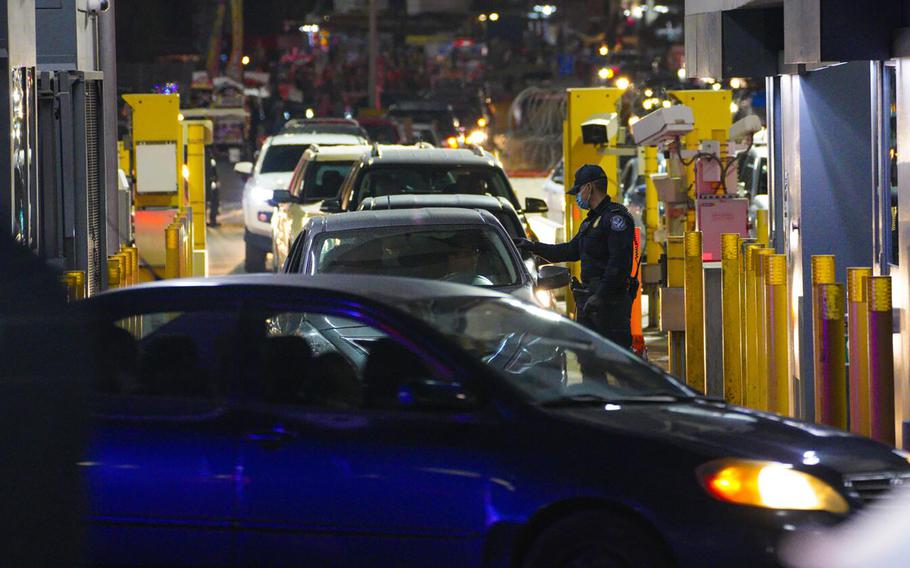 U.S. Customs agents monitor and inspect vehicles entering the U.S. from Mexico at the San Ysidro Port of Entry near San Diego in December 2021.