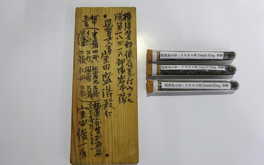 This wooden tablet and black sand from Iwo Jima were gifted to Noriko Kawarai, niece of fallen Japanese soldier Morihiro Murota, at the city hall in Kanuma, Japan, Dec. 20, 2022. 