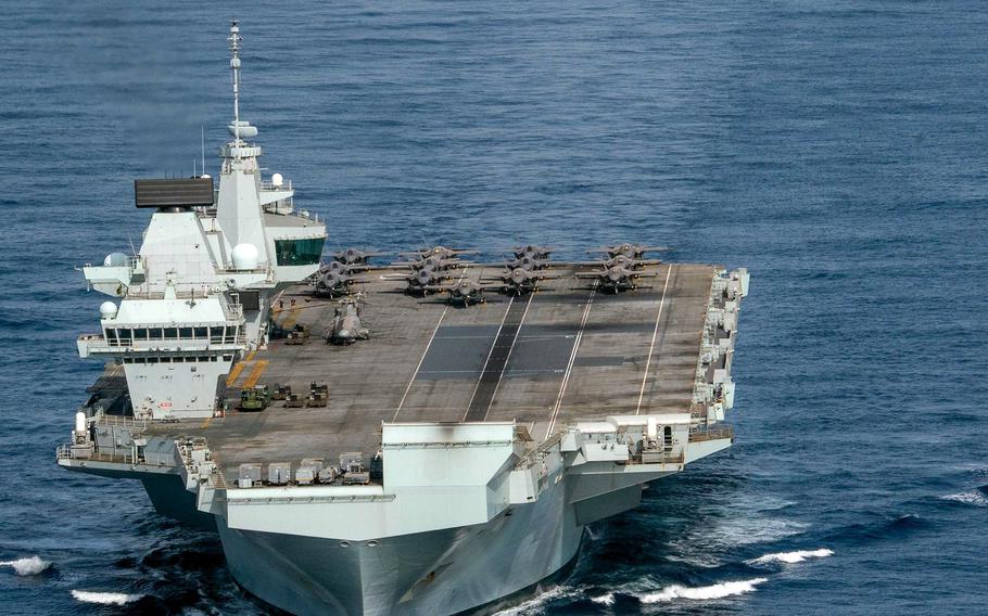 The Royal Navy aircraft carrier HMS Queen Elizabeth leads the guided-missile destroyer USS Halsey in the Gulf of Aden, July 12, 2021. 