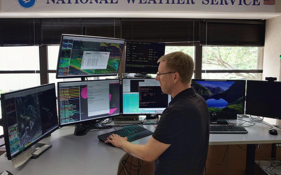 National Oceanic and Atmospheric Administration (NOAA) warning coordination meteorologist, John Bravender, reviews weather data in the National Weather Service forecast office.