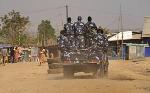 Soldiers are piled into a truck.