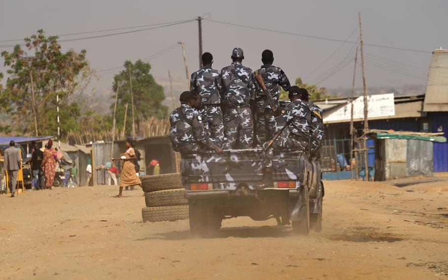 Soldiers are piled into a truck.