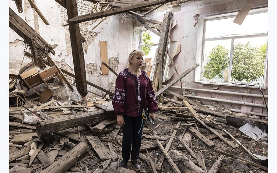Svitlana Mandrych, deputy mayor of Orikhiv, stands in one of the heavily damaged rooms at a municipal building. 