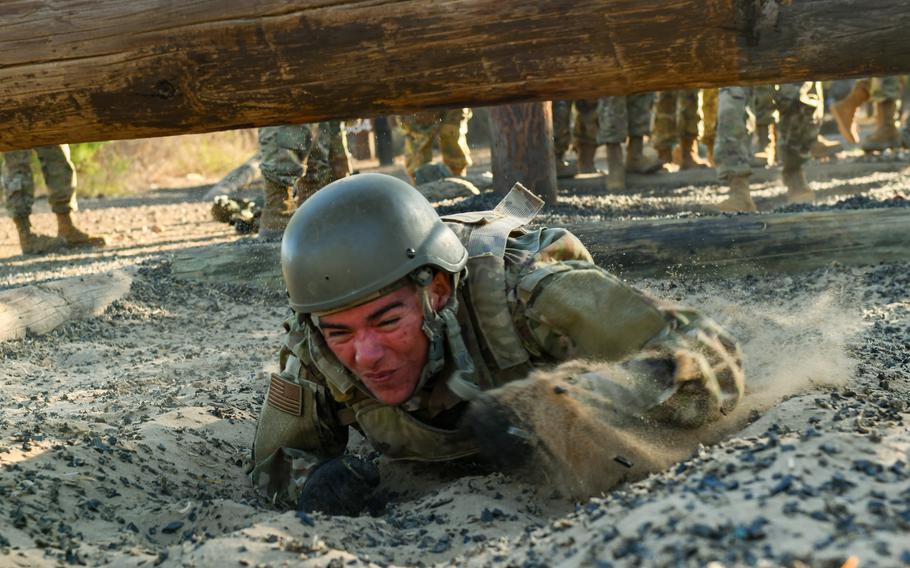 An Air Force trainee moves through an obstacle course at Joint Base San Antonio-Chapman Training Annex in Texas on Oct. 26, 2022. The airmen went through PACER FORGE, a new 36-hour exercise that tests teamwork, discipline and problem-solving skills of airmen during basic training.