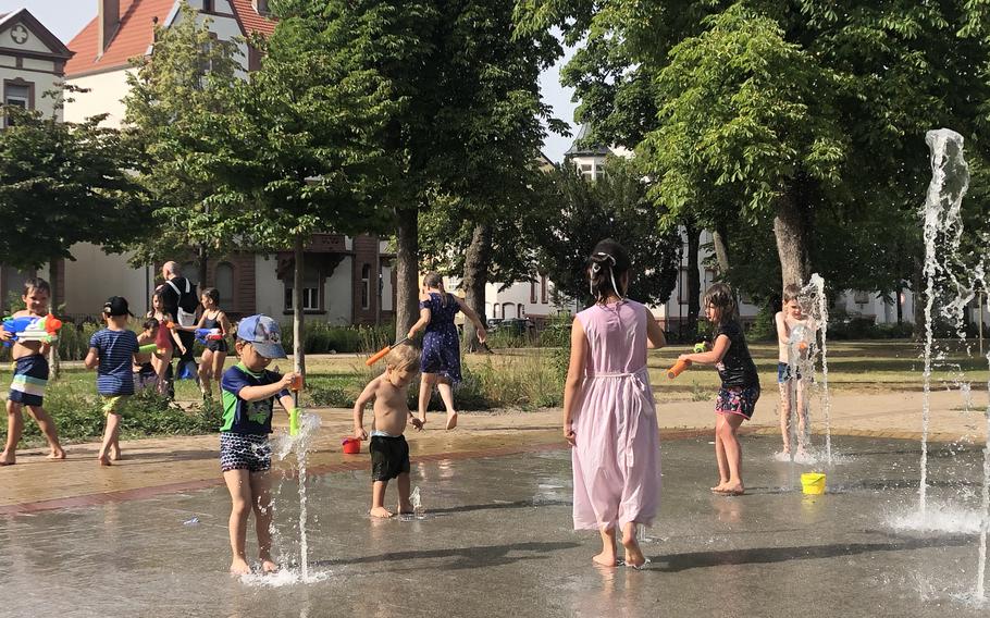 Children try to cool off at StadtPark in Kaiserslautern, Germany. To combat the energy crisis in Europe, the city passed a savings plan.