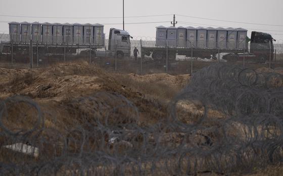 Trucks carrying humanitarian supplies for the Gaza Strip wait in line on the Egyptian side of the Kerem Shalom Crossing on April 25, 2024.