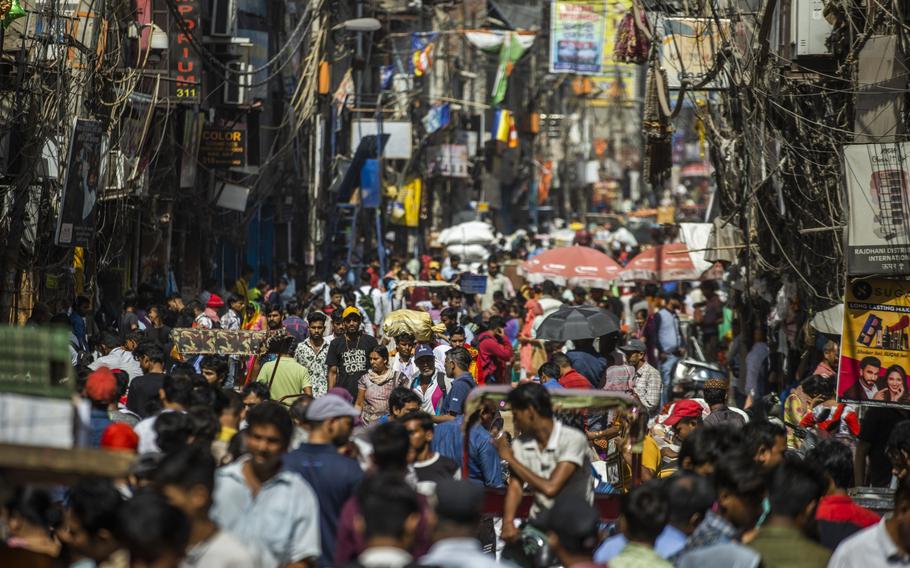 People walk through the Sadar Bazaar in New Delhi, India, on Tuesday, April 18, 2023. India has overtaken China as the world’s most populous nation, according to U.N. data released on April 19. 