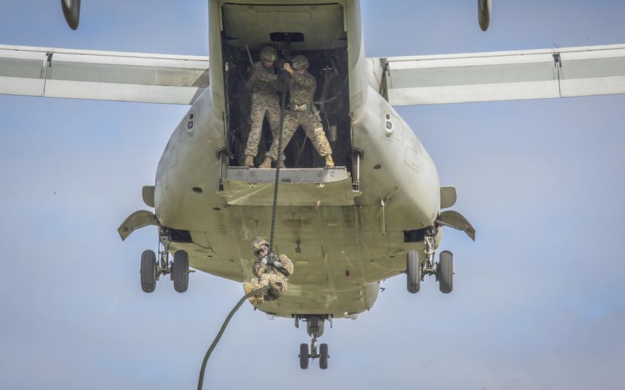 Marines fast rope from an Osprey tiltrotor aircraft at Camp Hansen, Okinawa, Japan, Nov. 28, 2017.