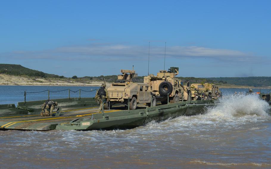 Combat vehicles are transported across Belton Lake at Fort Cavazos, Texas, as part of a division-level training exercise Nov. 3, 2023. 