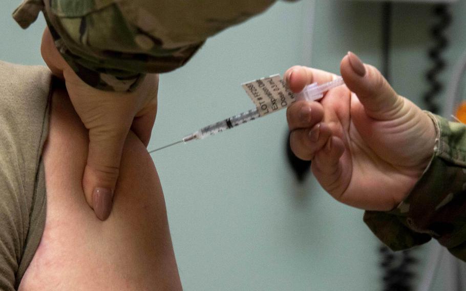 An airman receives a COVID-19 vaccination at MacDill Air Force Base, Fla. in 2021. Nine airmen have filed a class action lawsuit against Air Force Secretary Frank Kendall and Defense Secretary Lloyd Austin because their requests to be exempted from COVID vaccinations were denied.