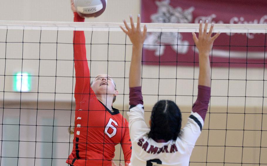 E.J. King's Madylyn O'Neill spikes the ball past Matthew C. Perry's Chelsea Campbell during Saturday's DODEA-Japan volleyball match. The Cobras won 25-10, 25-15, 25-13, hours after also beating the Samurai 25-7, 25-10, 25-7 on Friday.