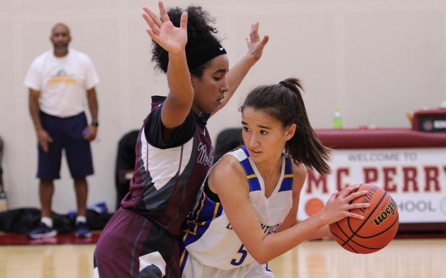 Yokota's Erica Haas looks for operating room against Matthew C. Perry's Ivanelis Nieves-Burmedez during Saturday's DODEA-Japan girls basketball game. The Panthers won 42-27.