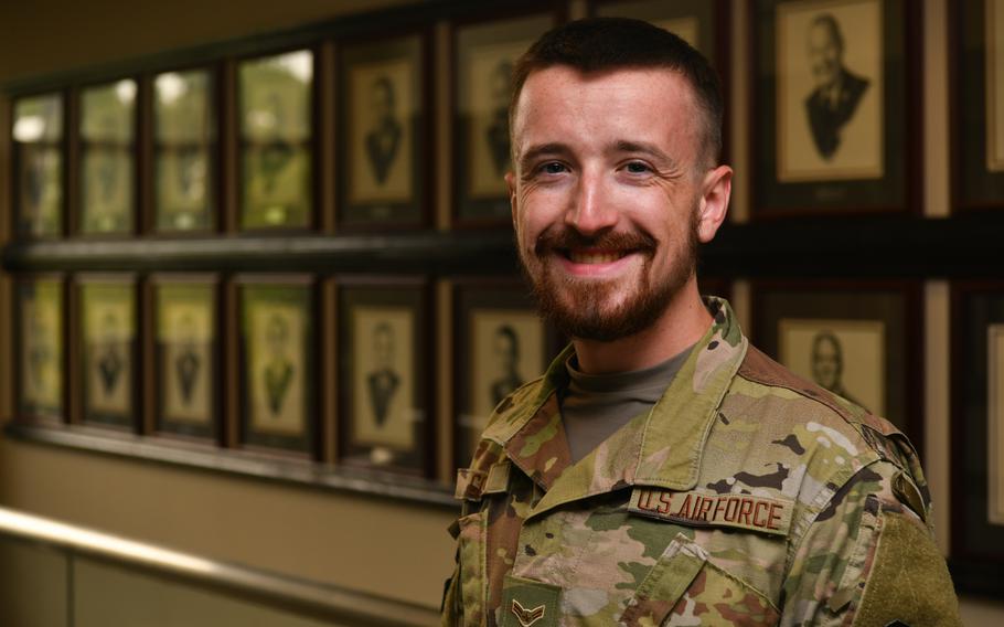 Airman 1st Class Braxton Comer, a student services technician with the Community College of the Air Force, smiles at Maxwell-Gunter Annex, Ala., July 27, 2021. A practicing Norse Pagan, Comer requested a religious accommodation waiver to grow a beard. A new Air Force regulation update solidified male airmen's eligibility for religious and medical facial hair accommodations.