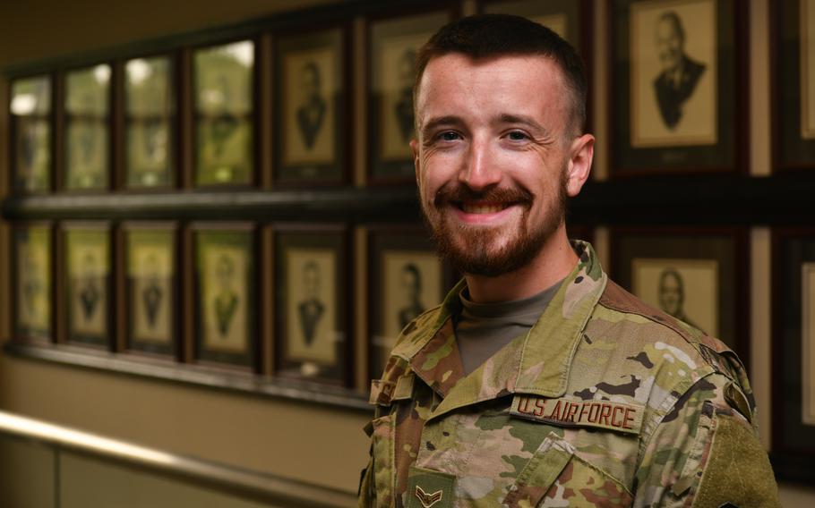Airman 1st Class Braxton Comer, a student services technician with the Community College of the Air Force, smiles at Maxwell-Gunter Annex, Ala., July 27, 2021. A practicing Norse Pagan, Comer requested a religious accommodation waiver to grow a beard. A new Air Force regulation update solidified male airmen's eligibility for religious and medical facial hair accommodations.