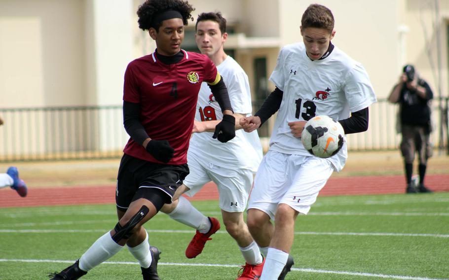 E.J. King's Kai Sperl and Matthew C. Perry's Shion Fleming chase the ball during Saturday's DODEA-Japan soccer match. The Samurai won 3-1.