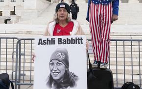 Witthoeft holds a sign with Babbitt’s photo.