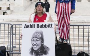 Witthoeft holds a sign with Babbitt’s photo.