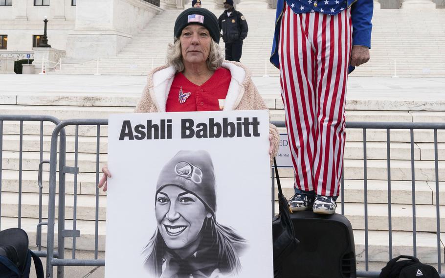 Witthoeft holds a sign with Babbitt’s photo.