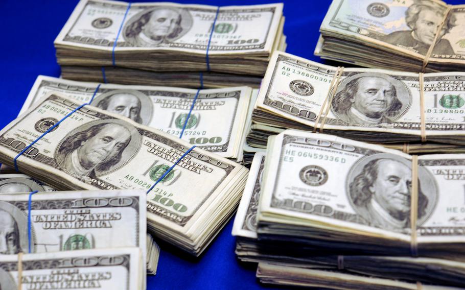 Piles of money on a blue background.