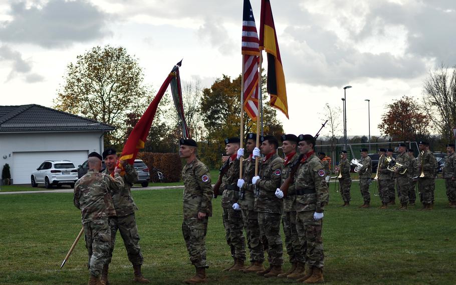 Gen. Christopher Cavoli, commander of U.S. Army Europe and Africa, hands the 56th Artillery Command guidon to  Maj. Gen. Stephen Maranian during the unit's reactivation ceremony in Wiesbaden on Nov. 8, 2021. 