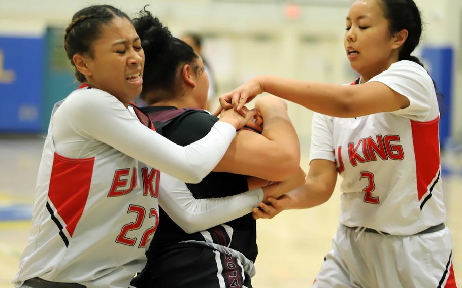 King's Mila Nishimura-Reed and Katelyn Mapa tangle with Zama's Deborah McClendon for the ball.