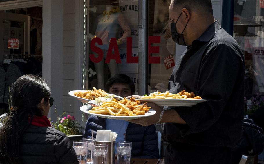 A worker serves food at a restaurant on Pier 39 in San Francisco. 