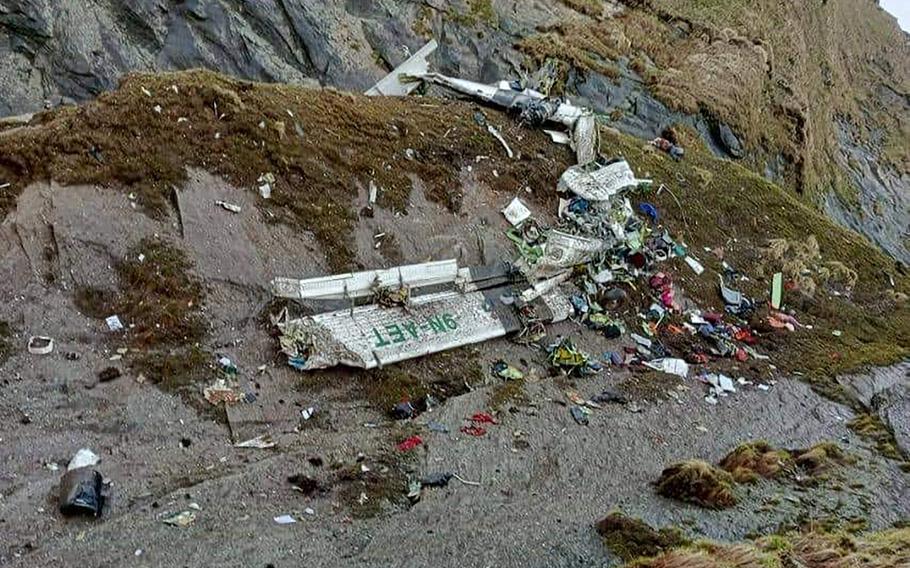 This handout photograph released by Fishtail Air, shows the wreckage of a plane in a gorge in Sanosware in Mustang district close to the mountain town of Jomsom, west of Kathmandu, Nepal, Monday, May 30, 2022. 