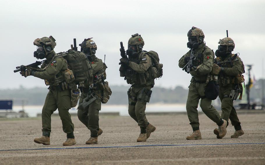 Marines from Portugal, England and the United States conduct a coordinated beach assault in Troia, Portugal, on Nov. 5, 2015, in front of a crowd of high ranking military generals, political and defense officials from a wide range of NATO countries.  