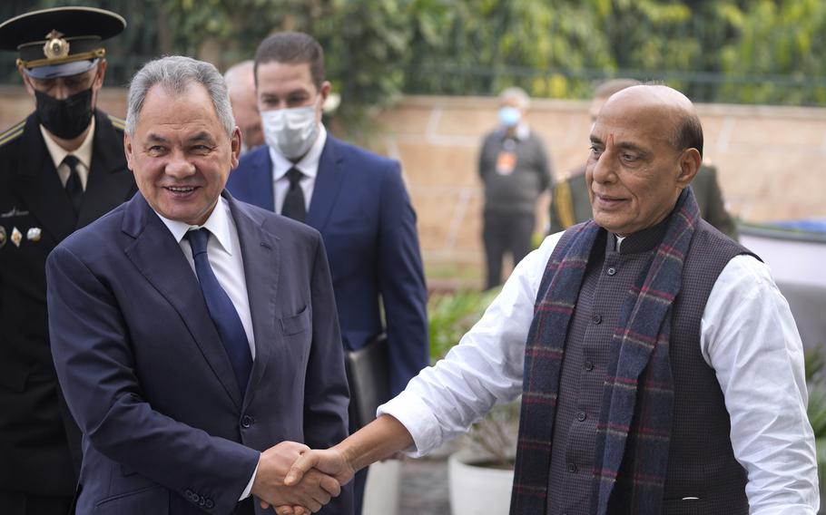 Indian Defence Minister Rajnath Singh, right, shakes hand with his Russian counterpart Sergey Shoygu in New Delhi, India, Monday, Dec. 6, 2021. Indian Prime Minister Narendra Modi meets with Russian President Vladimir Putin on Monday to discuss defense and trade relations as India attempts to balance its ties with the United States. 