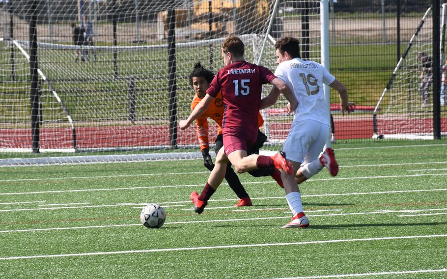 Lakenheath's Mattias Sadler takes a shot against Ramstein while Royals goalkeeper Favian Pierre-Lous tries to stop him. Sadler scored the only goal for the Lancers in the 5-1 loss against Ramstein on Saturday, April 16, 2022.