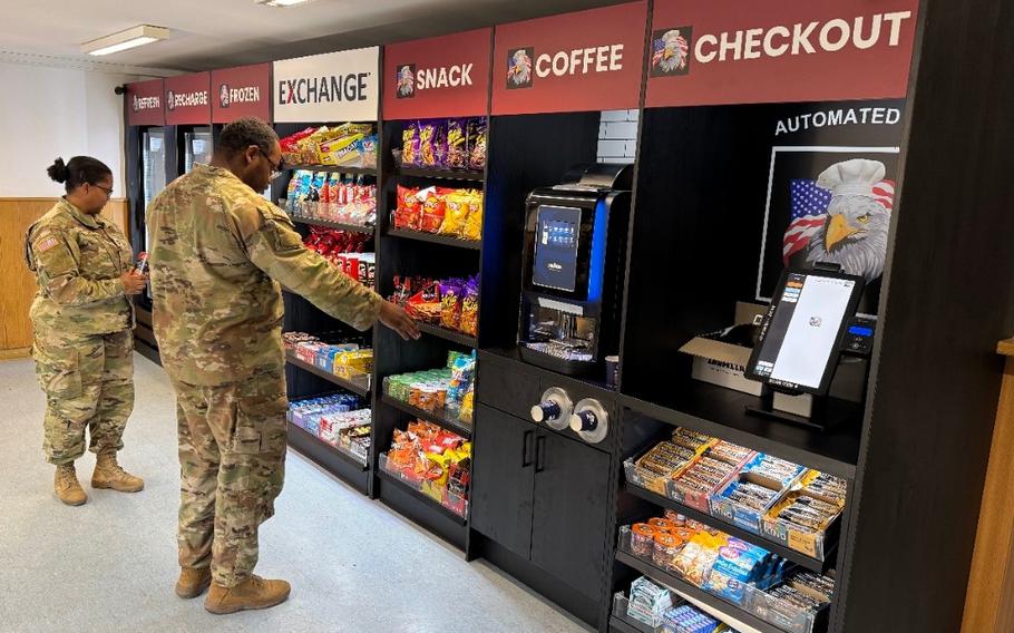 Uniformed service members shop at an unmanned convenience store.