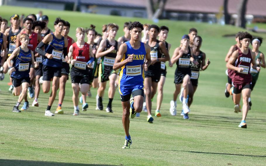 St. Mary's William Beardsley pulls ahead of the pack early in the Far East cross country meet boys race. Division II winner Tyler Gaines of Matthew C. Perry is to the right.