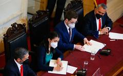 Leaders of the Constitutional Convention, Maria Elisa Quinteros, second from left, and Gaspar Dominguez, third from left, attend a ceremony to deliver the final draft of a proposed, new constitution inside the former Congress in Santiago, Chile.