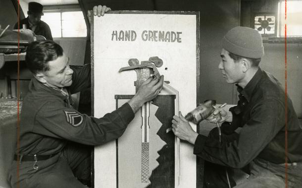 Hed: Just don't drop the real thing, 1961

Yongsan Garrison, South Korea, December 1961:    Chi Jung Kim (right), carpenter shop supervisor and S/Sgt. Dell E. Carter, non-commissioned officer in charge at the Eight Army Training Aids Center finish the build of a grenade mock-up, showing the inside workings of a hand grenade.  

The center provides any equipment or device needed as training aid for military classes throughout the United Nations Command. Most of the items – anything from lecterns and pointers to hurdles for sentry dog training and even a fake human arm with “blood” for medic training - are stocked in the Yongsan warehouse. 

Regular shipments from the Naval Training Devices Center and the Department of the Army take care of some of the supplies, but many of the items – such as the fake arm – are constructed by local Korean members of the center themselves. The unit is run by two officers, and they are the only military personnel in the outfit.

Pictured here is a scan of the original 1961 print created by Stars and Stripes Pacific's photo department to run in the print newspaper. The red marks indicate the crop lines. Only the middle part of the image would appear in the newspaper. 

As the vast majority of pre-1964 Stars and Stripes Pacific negatives and slides were unwittingly destroyed by poor temporary storage in 1963, the prints developed from the late 1940s through 1963 are the only images left of Stripes' news photography from those decades – with the exception the negatives of some 190 pre-1964 photo assignment found recently. 

Stars and Stripes' archives team is scanning these prints and negatives to ensure their preservation.
 
META TAGS:  U.S. Army; servicemember; military supplies; logistics; South Korean; locals; Yongsan Garrison