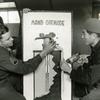 Hed: Just don't drop the real thing, 1961

Yongsan Garrison, South Korea, December 1961:    Chi Jung Kim (right), carpenter shop supervisor and S/Sgt. Dell E. Carter, non-commissioned officer in charge at the Eight Army Training Aids Center finish the build of a grenade mock-up, showing the inside workings of a hand grenade.  

The center provides any equipment or device needed as training aid for military classes throughout the United Nations Command. Most of the items – anything from lecterns and pointers to hurdles for sentry dog training and even a fake human arm with “blood” for medic training - are stocked in the Yongsan warehouse. 

Regular shipments from the Naval Training Devices Center and the Department of the Army take care of some of the supplies, but many of the items – such as the fake arm – are constructed by local Korean members of the center themselves. The unit is run by two officers, and they are the only military personnel in the outfit.

Pictured here is a scan of the original 1961 print created by Stars and Stripes Pacific's photo department to run in the print newspaper. The red marks indicate the crop lines. Only the middle part of the image would appear in the newspaper. 

As the vast majority of pre-1964 Stars and Stripes Pacific negatives and slides were unwittingly destroyed by poor temporary storage in 1963, the prints developed from the late 1940s through 1963 are the only images left of Stripes' news photography from those decades – with the exception the negatives of some 190 pre-1964 photo assignment found recently. 

Stars and Stripes' archives team is scanning these prints and negatives to ensure their preservation.
 
META TAGS:  U.S. Army; servicemember; military supplies; logistics; South Korean; locals; Yongsan Garrison