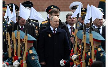 Russian President Vladimir Putin watches honor guards passing by during a flower-laying ceremony at the Tomb of the Unknown Soldier on Victory Day, which marks the 79th anniversary of the victory over Nazi Germany in World War Two, in central Moscow, Russia, May 9, 2024.