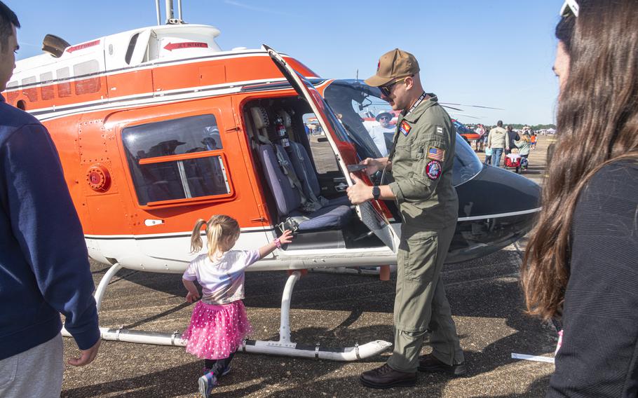 A TH-73A Thrasher helicopter pilot opens the aircraft door for Beyond the Horizon Air and Space Show attendees, Saturday, April 6, 2024. 