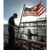 Apra Harbor, Guam, Nov. 7, 2000: Coast Guard Seaman Scott Braithwaite secures a line after raising the American flag on Tuesday morning aboard the Coast Guard cutter Galveston Island in Apra Harbor, Guam.

META TAGS: American flag; Coast Guard; Guam; Apra Harbor; USCGC Galveston Island; male